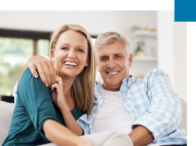 mature couple smiling with dental bridges, showing off their amazing smiles. 